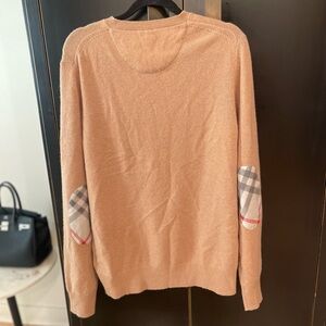 A Burberry crew-neck sweater in wool jersey.